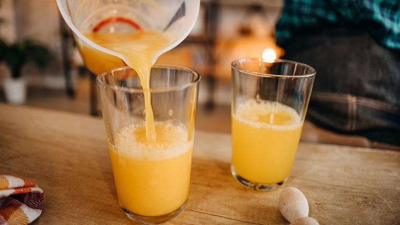 pouring orange juice into glass 