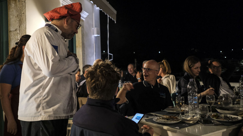 A chef chats with customers