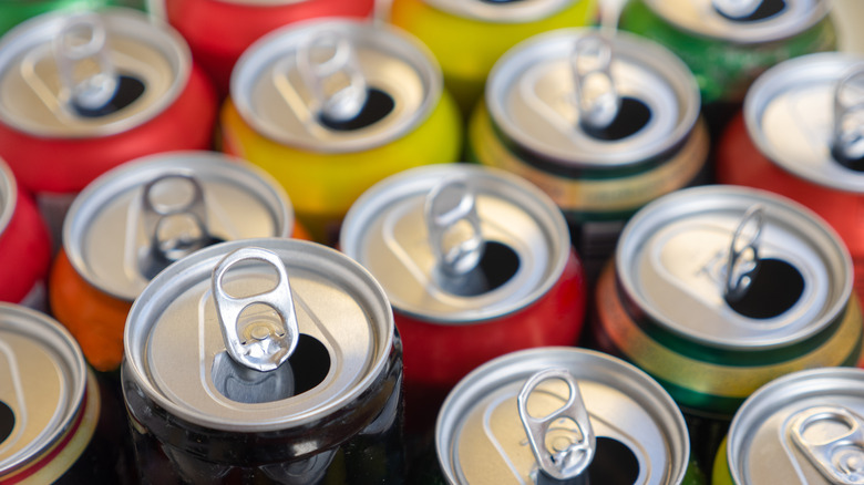 Empty cans of beer in various colors