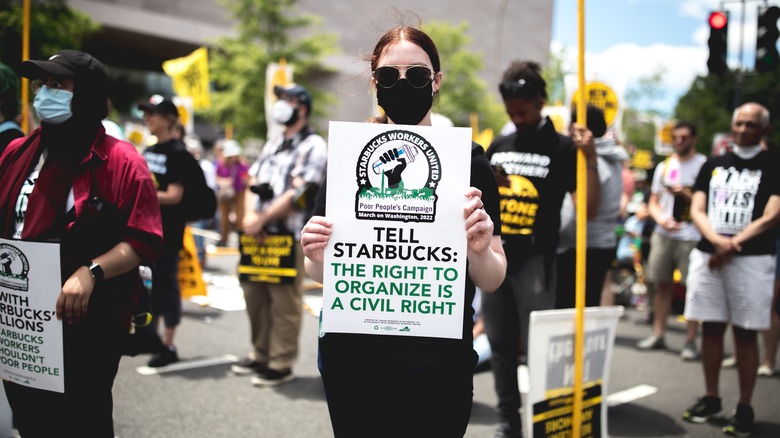 Protesters holding signs