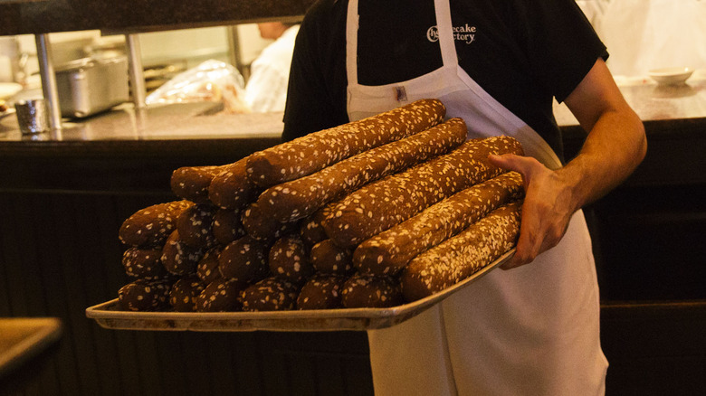 Waiter carrying Cheesecake factory bread