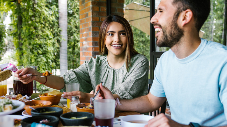 people eating at outdoor table