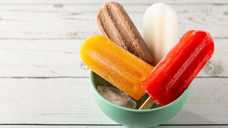 Different color popsicles in bowl