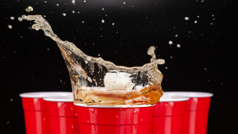 beer pong ball splashing into cup