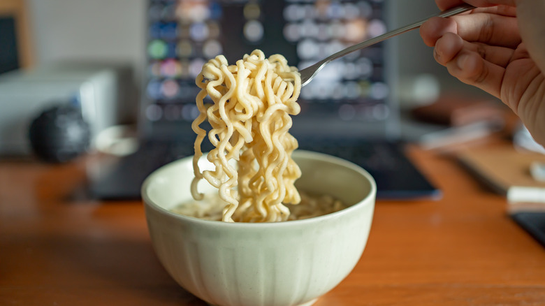 eating instant noodles from a bowl