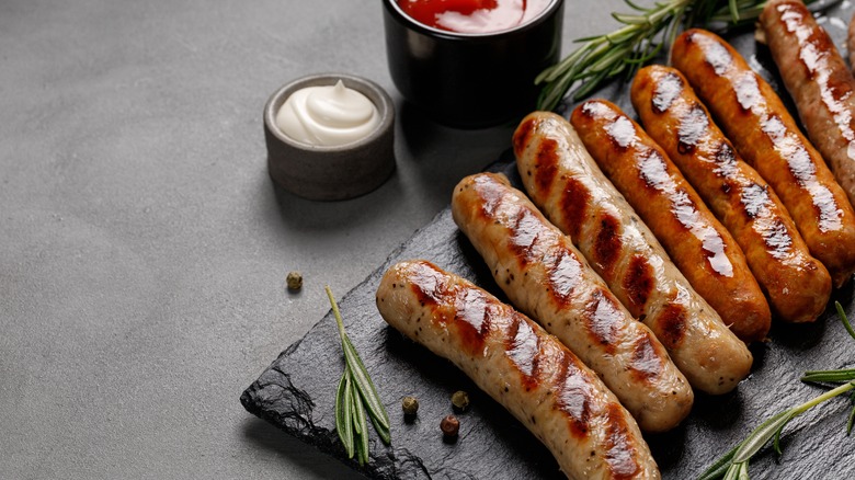 sausages on platter next to dips