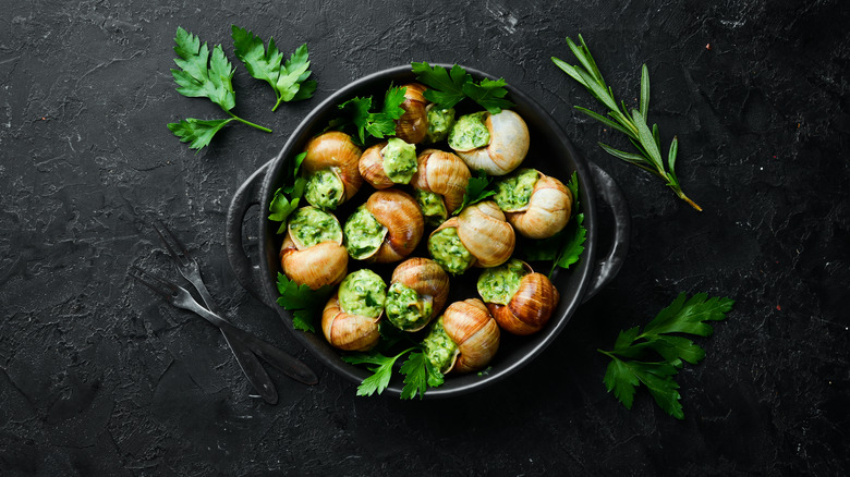 Raw escargot with garlic butter