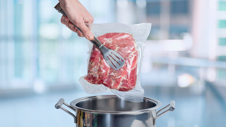 Vacuum-sealed beef about to go in a pot