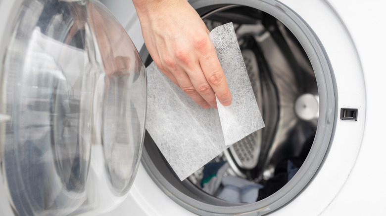 Dryer sheets being put in a dryer