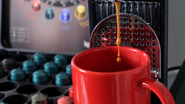 Nespresso machine pouring a cup of coffee