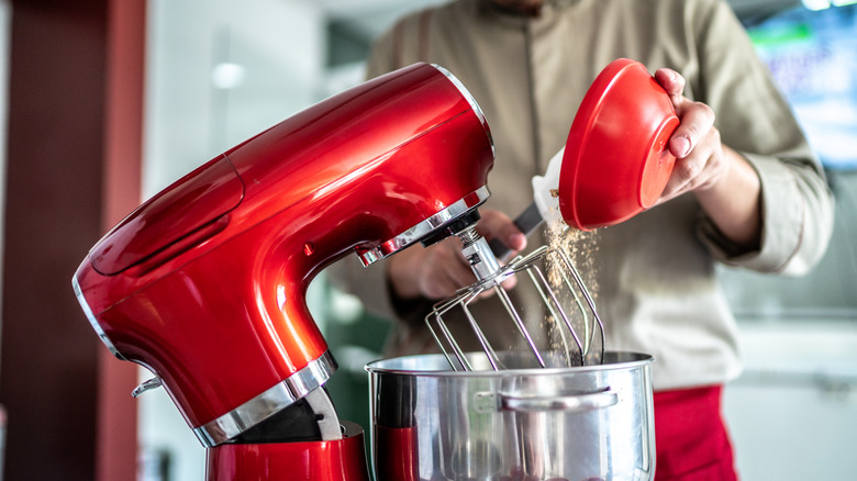 Large red stand mixer in use