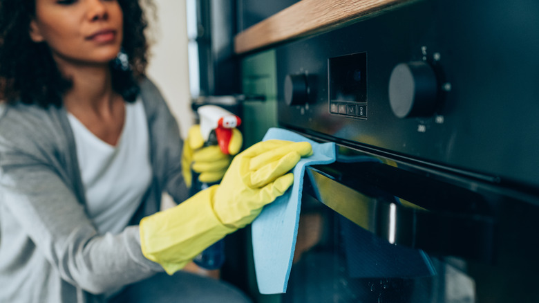 woman cleaning stove