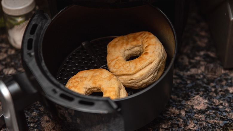 Biscuit donuts in air fryer basket 