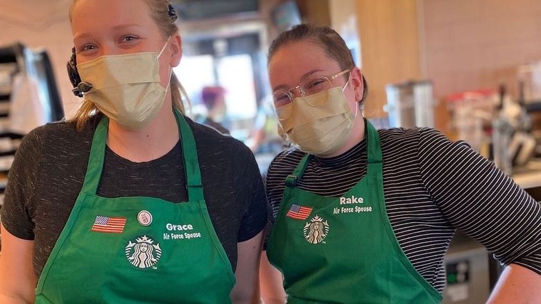 starbucks emloyees wearing green apron embroidered with american flag