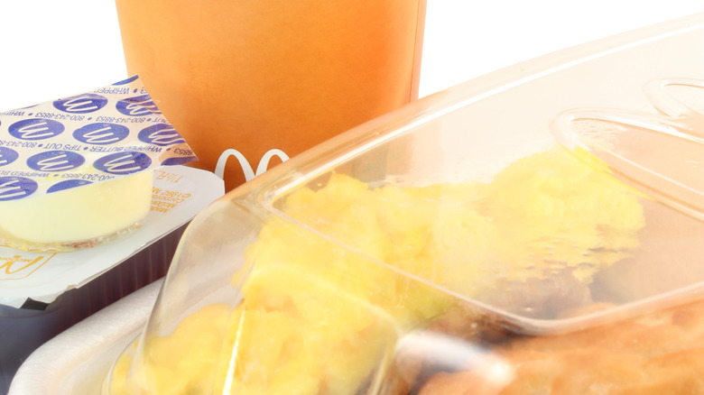 McDonald's breakfast tray with coffee cup in the background