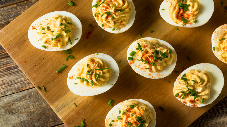 deviled eggs on a cutting board