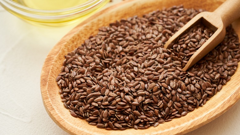 Whole flaxseeds in a wooden bowl