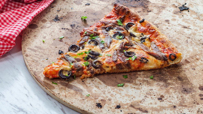 Pizza slice on a pizza stone