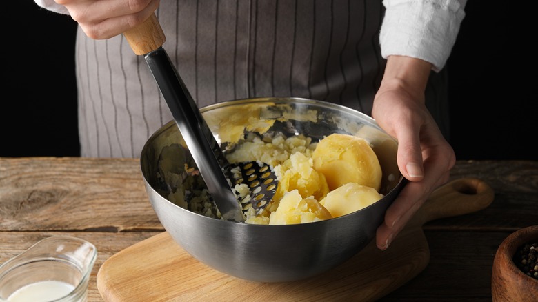 mashing potatoes by hand