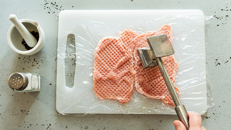 Chef hammering meat