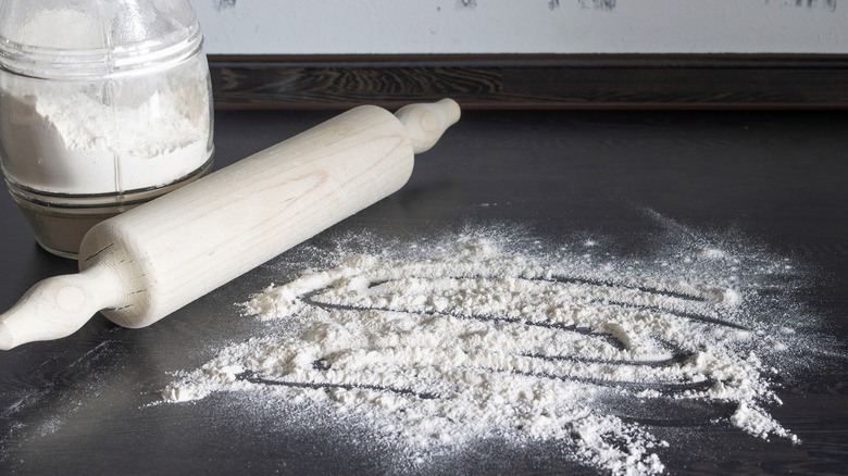 Flour on a table with rolling pin