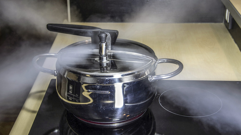 Pressure cooker releasing hot steam 