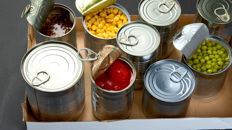 sealed and opened cans of vegetables