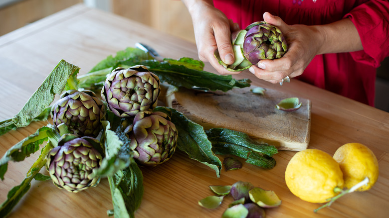 Prepping fresh artichokes for cooking