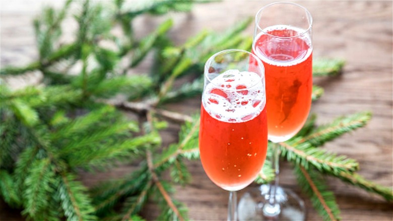 Champagne in flutes with conifer branches