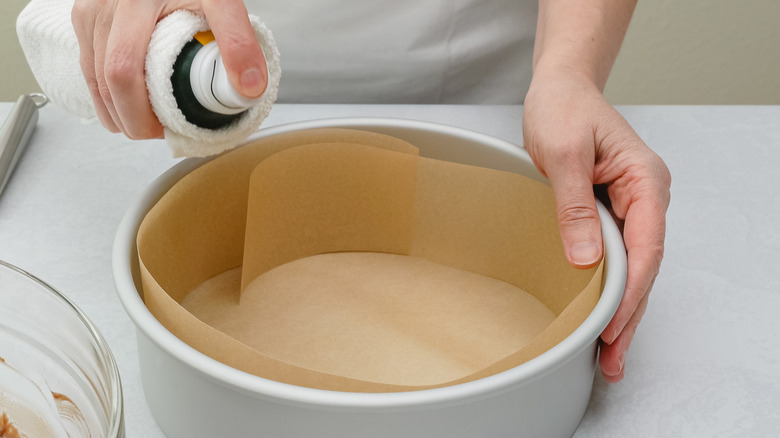 cooking spray and parchment in cake tin