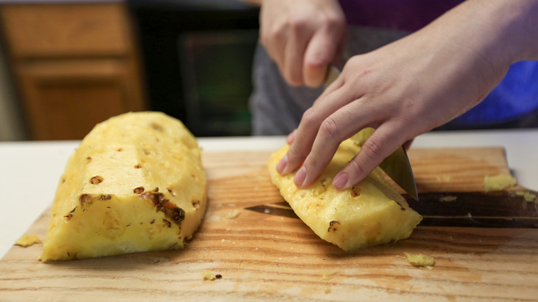 Cutting a whole pineapple