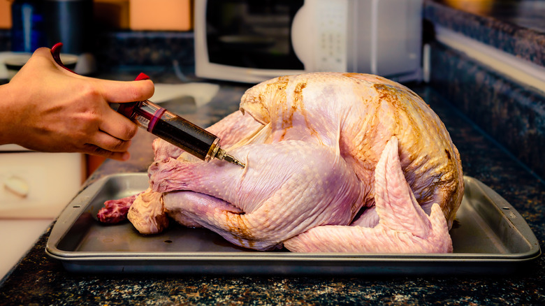 meat syringe injecting turkey