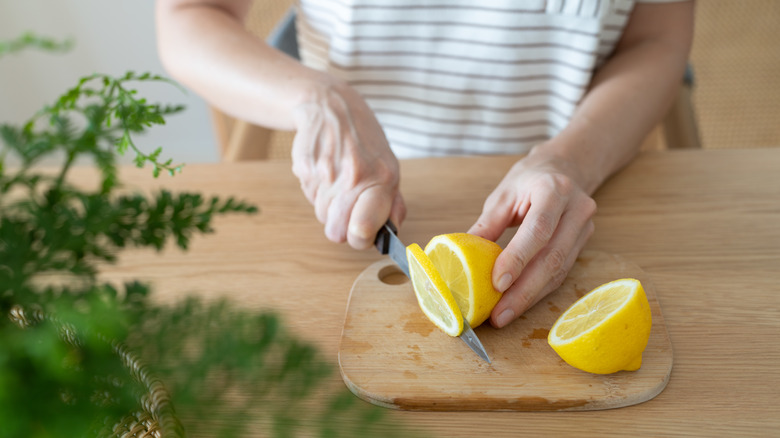 person cutting lemons