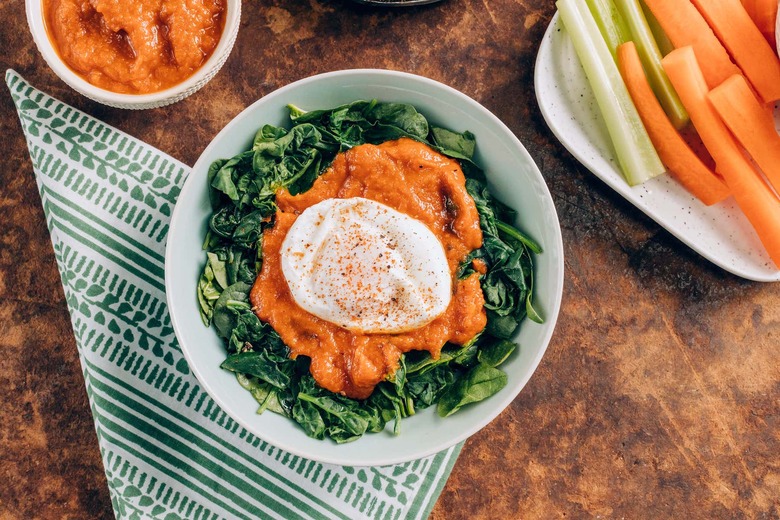 An array of homemade condiments: bacon ketchup & greens w/ poached egg; crudite w/ aioli; burger