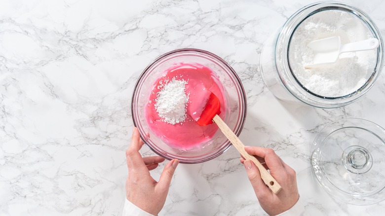 Mixing royal icing in a bowl