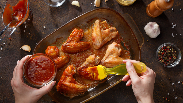 Person marinating chicken wings 