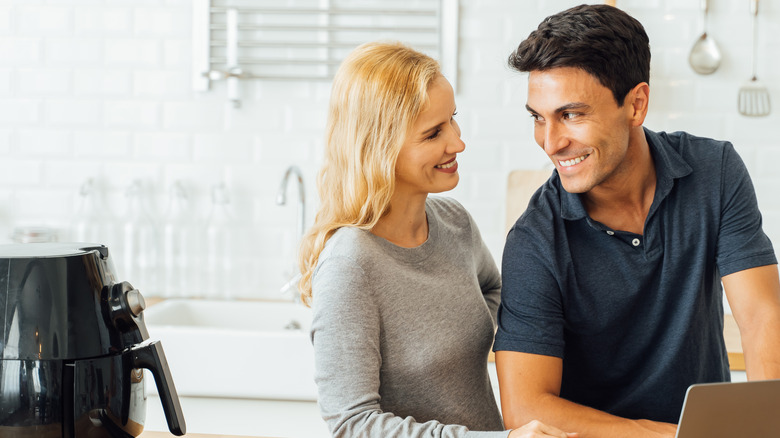 Couple waits on air fryer cooking