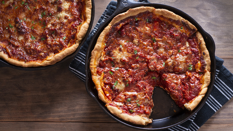 Overhead two deep dish pizzas