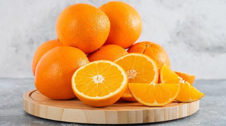 sliced oranges on wooden platter