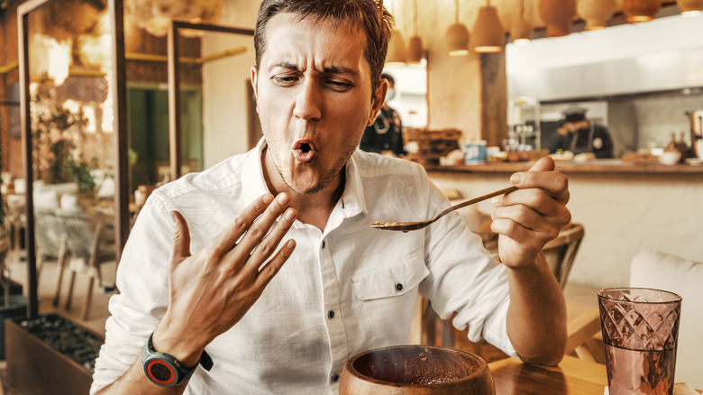 man eating spicy food