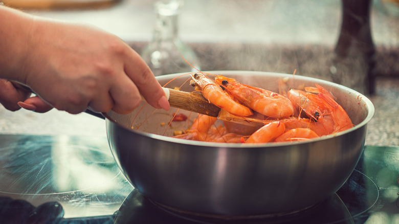 Person cooking shrimp