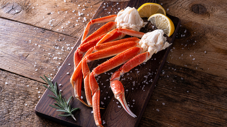 crab leg clusters on cutting board