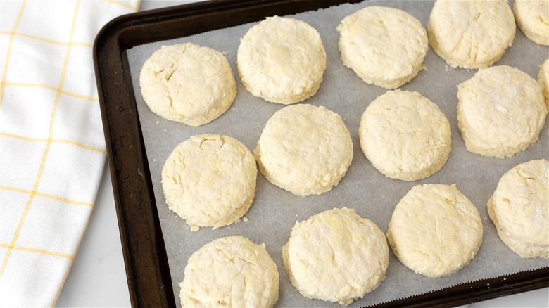 Raw biscuits on baking sheet 