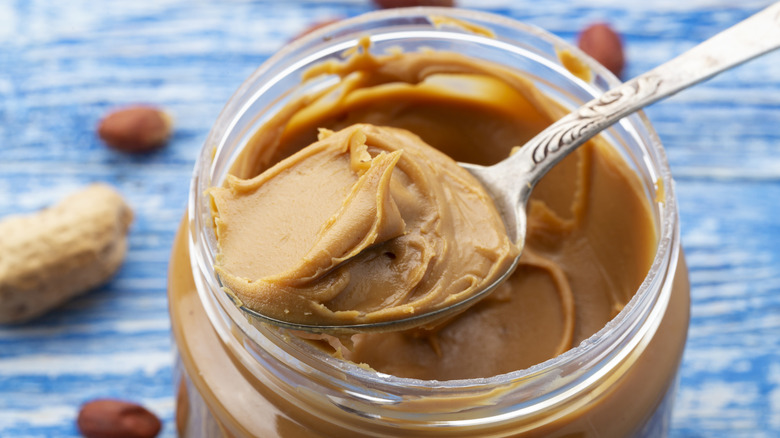 Spoonful of peanut butter on top of jar