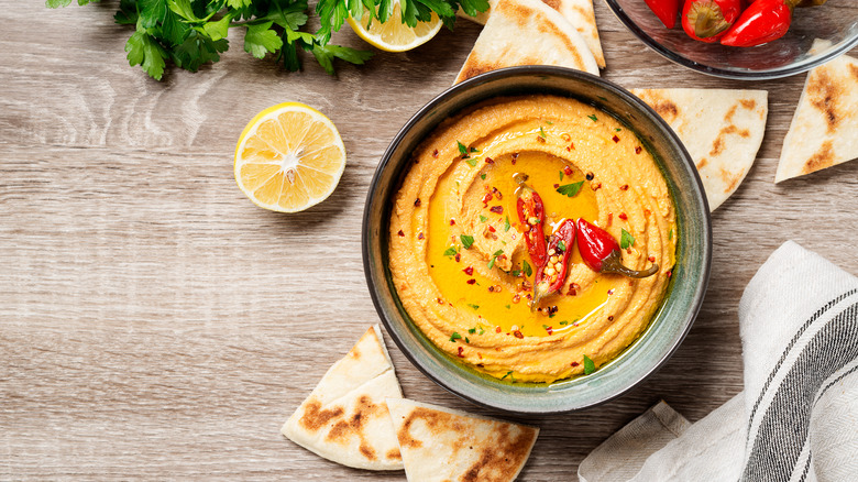 Hot red pepper hummus on wood table