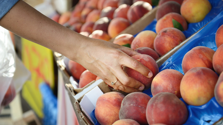 buying peaches at the store