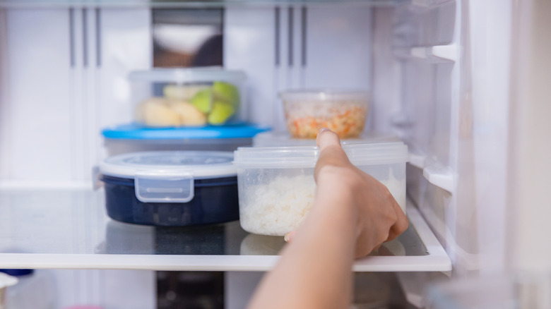 Person placing food in the fridge