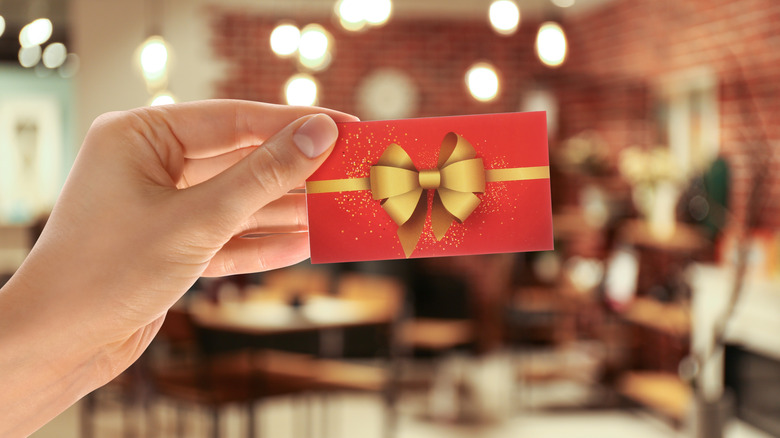 Person holding gift card in restaurant