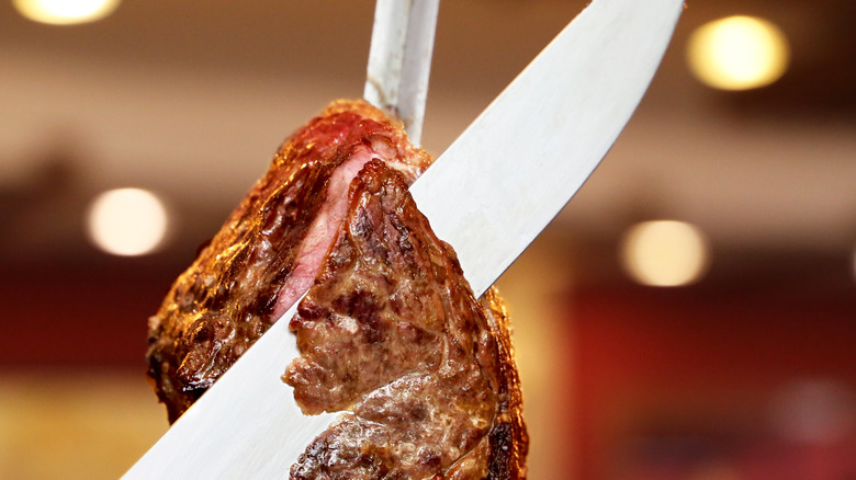 Slicing meat from skewer