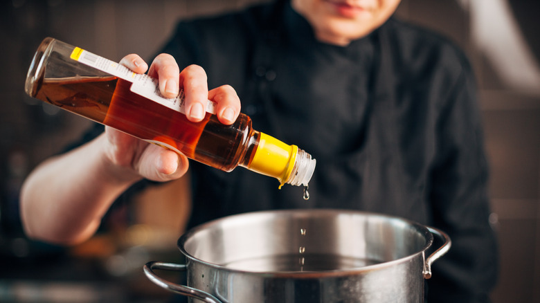 Woman cooking with white wine vinegar